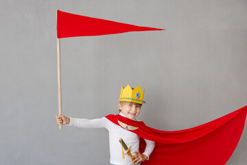 Child pretend to be knight. Kid having fun at home