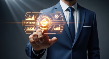 Businessman activating glowing fintech dashboard hologram against a dark background
