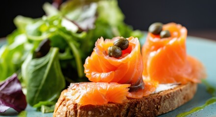 Smoked salmon canapé with mixed greens and capers on rustic sourdough bread