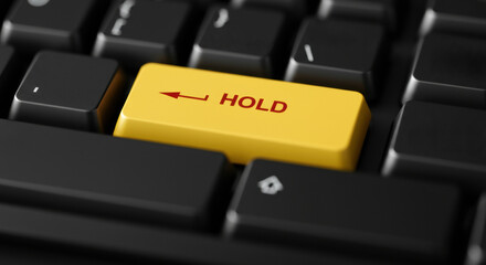 Yellow hold key on black keyboard symbolizing pause and control in closeup view