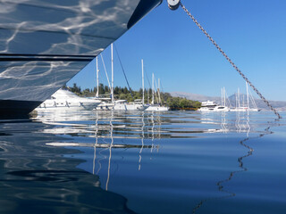 Moored yachts and sailboats on the coast of Atherinos Bay, Meganisi island, Ionian Sea, Greece.