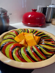 Preparing colorful vegetable ratatouille with pumpkin