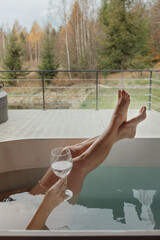 Relaxing bath experience with a glass of water in a modern tub