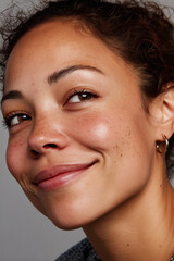 Charming mixed race woman portrait, clear moisturized skin