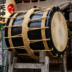 Traditional Japanese taiko drum on wooden stand at shrine