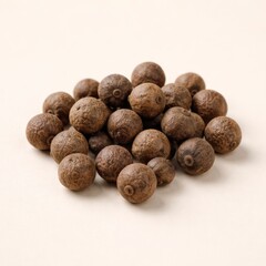 A neat mound of dried allspice berries rests on a clean pale surface, ideal for spice packaging, cooking blogs, ingredient lists, and minimalist food branding visuals.