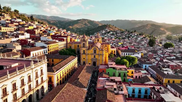 Aerial view of colorful colonial city architecture and hills under a bright sky