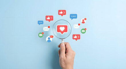 hand holding magnifying glass with social media icons