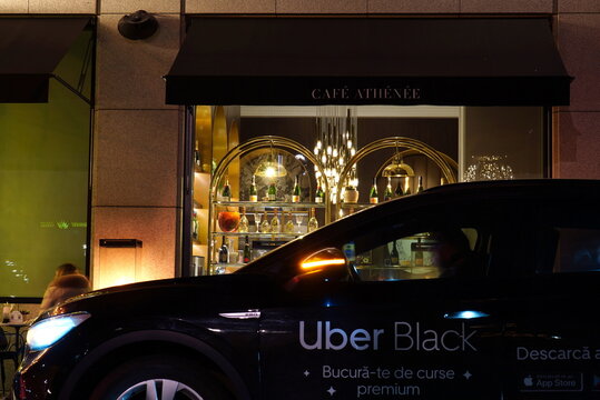 Bucharest, Romania &ndash; January 2, 2026: Car of Uber ride sharing company, the Black premium option, passing by Athenee Palace Hotel&rsquo;s cafe 