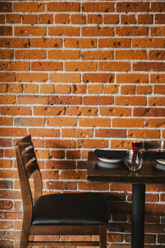 two chairs on a brick wall