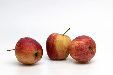 Ripe wet apples on a white background