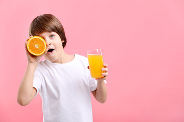 Boy with glass of fresh orange juice and fruit on pink background. Space for text