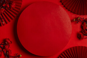 Red circular podium with traditional Chinese decorative elements on a rich red background.