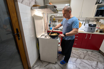 Man cooking pasta in wok