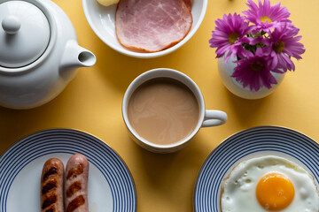 Sausages fried egg and ham breakfast with coffee on a yellow table
