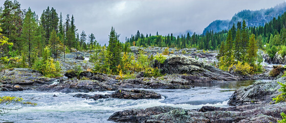 Lapland landscape with rapid river flowing through rocks