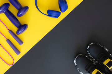 Fitness essentials dumbbells jump rope and sneakers for workout, flat lay