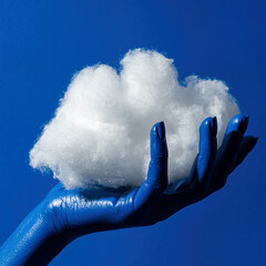 Artistic representation featuring a blue hand holding a fluffy cloud against a blue background