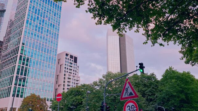 FRANKFURT, GERMANY - AUGUST 15, 2025: Banking district skyscrapers tilt-up shot. Establishing B-roll for finance, economy, and global business concepts. Modern European city lifestyle at daytime.