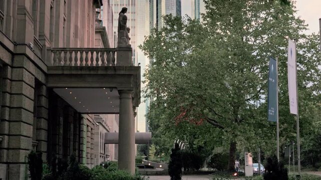 FRANKFURT, GERMANY - AUGUST 15, 2025: Vertical tilt-up view of skyscrapers in financial district. Cinematic city skyline B-roll footage for news, documentaries, and travel reports at daylight.