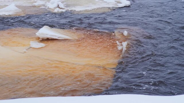 Churning Water and Icy Layers in a Wintry Stream - Melting Ice Floes in a Cold River Flow During Winter