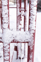 Bus stop benches covered with fresh snow on a cold winter day in the city