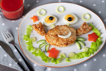 Fun breakfast idea for kids: turkey cutlet shaped like crab with eyes made from a boiled egg and olives