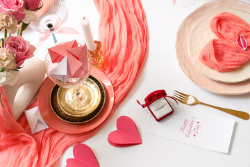 Table setting for Valentine's Day with engagement ring, top view
