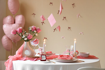 Dining table set for Valentine's Day with engagement ring and hanging letters in room