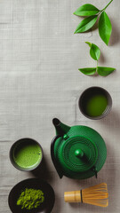 Top view of traditional matcha tea set with green teapot and bamboo whisk on linen cloth