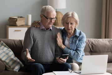 Pension planning challenges. Confused aged spouses retirees review monthly expenses at home office...