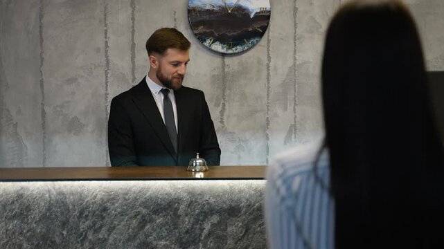 Hotel receptionist welcoming guest at check in counter