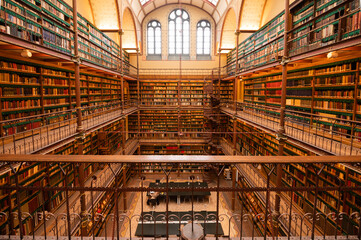 Historic library interior with wooden bookshelves and gallery Amsterdam