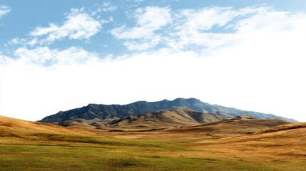 Fototapeta premium Scenic view of rolling hills and blue sky with distant mountains.
