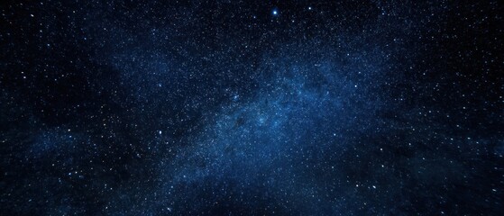 Fototapeta premium Night sky abstract image featuring numerous stars against a dark blue background