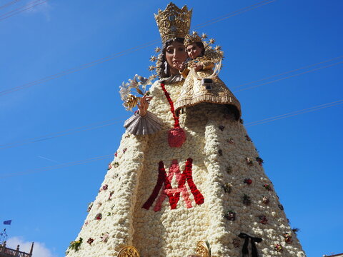 Las Fallas Festival 2025 in Valencia, Spain. A traditional celebration of spring and fire. The Virgin Mary's figure in Plaza de la Virgen, decorated with flowers, after the La Ofrenda procession.