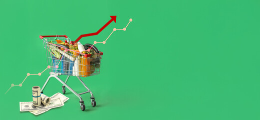 Shopping cart full of food on green background © Pixel-Shot