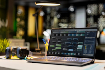 Luxurious modern office space with important reports on laptop, empty desk showcasing important data analytics and insight for management and business administration tasks. Forecasting.