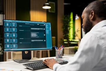 Male PC user interacting with AI chat system on computer at office after hours, highlighting the evolution of artificial intelligence. Chatbot services and digital tools for productivity.