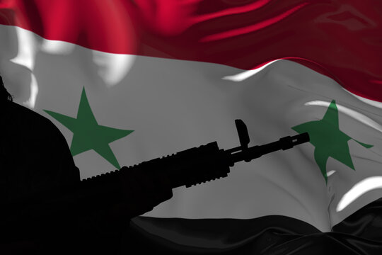 Silhouette of an armed soldier with a machine gun against the background of the Syrian flag.