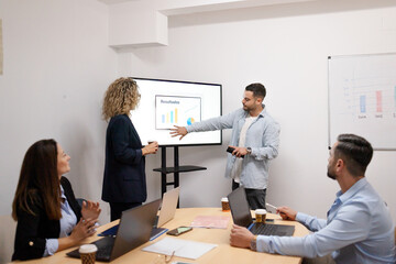 Business colleagues presenting data during office meeting