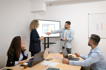 Business team discussing results during corporate meeting