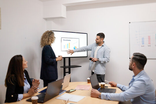 Business colleagues presenting data during office meeting - Powered by Adobe