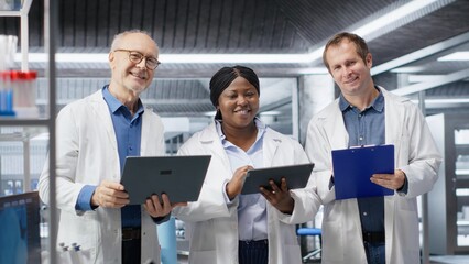 Portrait of diverse group of experts in the science lab conduct a research study, reflecting diagnostics and laboratory analysis. Staff advancing biochemistry and healthcare innovation.