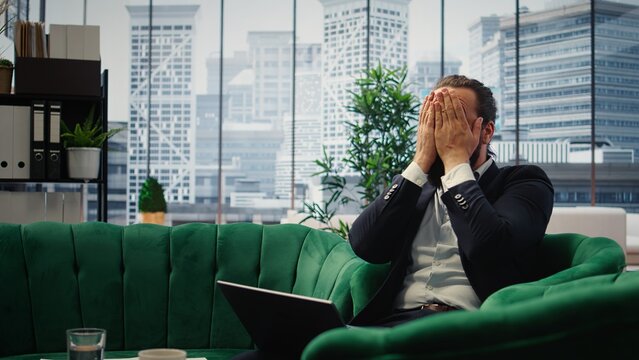 Overburdened director dealing with workload and financial instability, struggling to keep his business economy on the line. Unsuccessful anxious man feeling hopeless due to problems. Camera A.