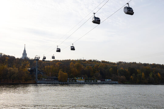 Cable Cars Glide Over the River in a Scenic Autumn Landscape