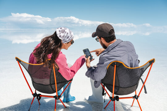 Tourist Couple enjoying the amazing landscape with phone