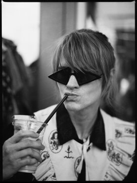 Portrait with a drink and funky glasses