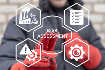 Industry engineer using virtual touch screen presses the text RISK ASSESSMENT. Risk assessment and crisis analysis industrial production concept.