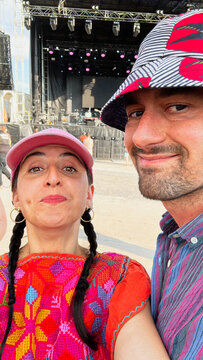 Friends Enjoying a Music Festival in Colorful Outfits Outdoors